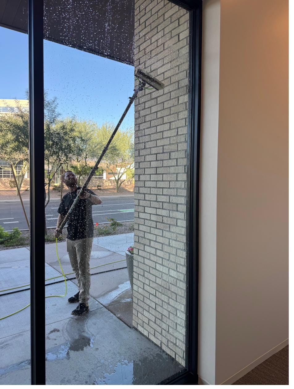 Commercial storefront window cleaning with a water-fed pole